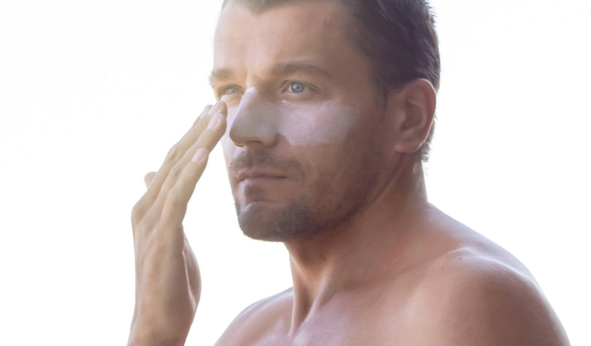 man applies sunscreen man applies sunscreen